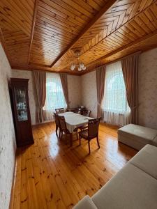 a dining room with a table and chairs in a room at Palm Garden House Lankaran in Lankaran