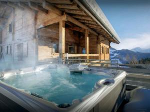 a hot tub on the side of a building at Pralor Le Peille - OVO Network in Manigod