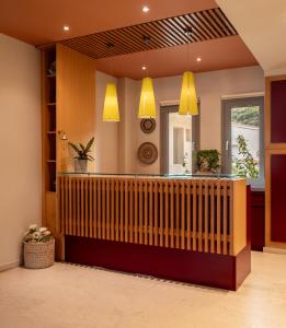 a lobby with a reception counter with yellow lights at Astoria Hotel in Troulos +50 photos