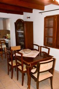 a wooden table and chairs in a kitchen at Nonna Sofia in Krikellos