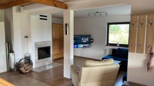 a living room with a couch and a fireplace at Ranczo Obozin 62 in Obozin