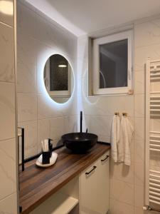 a bathroom with a black bowl sink on a counter at HARMONY STONE ViLLA in Ovčar Banja +12 photos