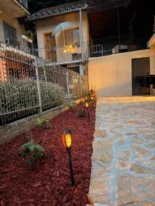 a courtyard of a house with lights in the yard at HARMONY STONE ViLLA in Ovčar Banja
