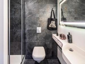 a bathroom with a toilet and a shower and a sink at ibis Brest Centre in Brest +41 photos
