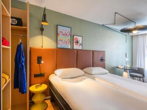 a bedroom with a large white bed in a room at ibis Cannes Centre in Cannes