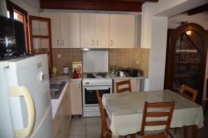 a kitchen with a table and a stove top oven at Nonna Sofia in Krikellos