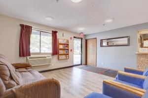 a living room with a couch and a chair at Coldwater Inn & Suites near I 69 in Coldwater