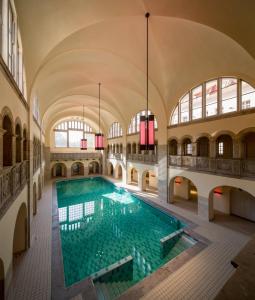 an indoor swimming pool in a building with windows at Hotel Oderberger in Berlin
