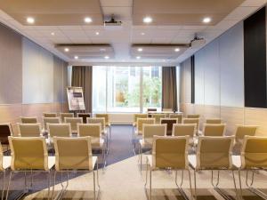a room with rows of chairs and a podium at Novotel Paris Charenton le Pont in Charenton-le-Pont