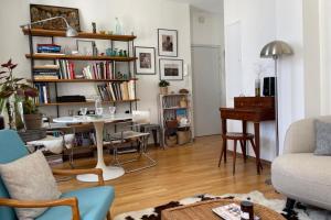 a living room with a table and a piano at Bright apartment - old renovated building in Nantes