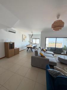 a living room with a couch and a table at Vila Rio DOuro in Ferragudo