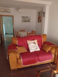a couch with pillows on it in a living room at Lagunas Ruidera 9 in Ruidera +1 photo