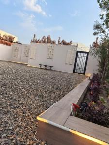 a bench sitting in front of a white building at شاليهات سكوْن in Al Baha