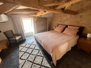 a bedroom with a large bed in a stone room at La Serva in Les Lèches