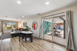 a living room with a couch and a table at Acacia Retreat by Rather Be Properties in Palm Springs