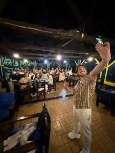 a man standing in a room with his arms in the air at El Rancho de Salento in Salento +124 photos