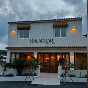 a white building with a ball participant sign on it at BALADRAR by Maxim in Benissa