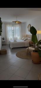 a bedroom with a bed and a potted plant at BALADRAR by Maxim in Benissa