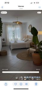 a picture of a bedroom with a bed and a plant at BALADRAR by Maxim in Benissa