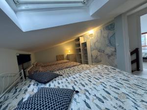 a bedroom with a large bed with two pillows on it at BeachfrontGrado Seaview Apartment Costa Azzurra in Grado +16 photos