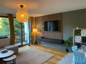 a living room with a flat screen tv on a wall at Cedron Apartments in Benecko