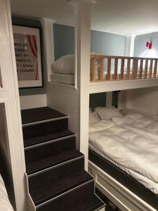 a bedroom with a bunk bed and a bunk staircase at The Malt House Inn in Gothenburg