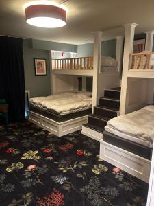 a room with two bunk beds and a staircase at The Malt House Inn in Gothenburg