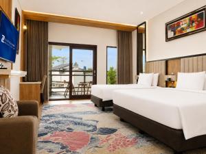 a hotel room with two beds and a balcony at Zenith Sunshine in Lebakwangi