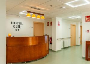a hospital lobby with a hotel ghr sign on the wall at Hotel GR in Tobarra