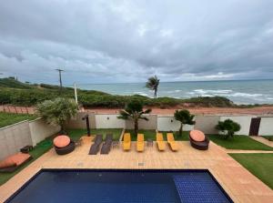 a view of a swimming pool and the ocean at Vilamar in Tibau do Sul