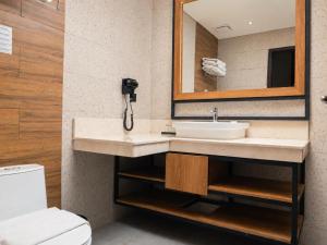 a bathroom with a sink and a mirror at Zenith Sunshine in Lebakwangi +188 photos
