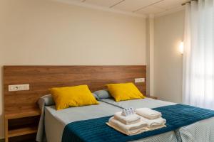 a bedroom with a bed with towels on it at Hotel GR in Tobarra