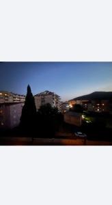 a view of a city at night with lights at Apartman Angela in Budva