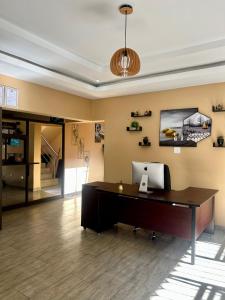 an office with a desk with a computer on it at Piink Lopez in Manzini