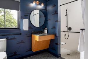 a blue bathroom with a sink and a mirror at The Foreside Inn in Kittery +27 photos