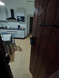 a door to a kitchen and a table in a room at Casa Engy in Rocca Imperiale