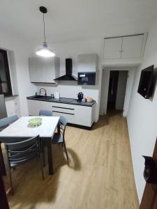 a kitchen and dining room with a table and chairs at Casa Engy in Rocca Imperiale