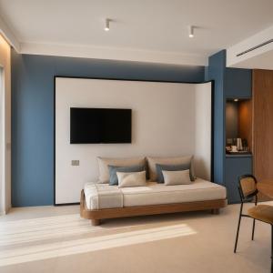 a bedroom with a bed with a tv on the wall at Paestum Inn Beach Resort in Paestum