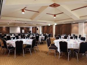 a conference room with tables and chairs in it at Novotel Vines Resort Swan Valley in Upper Swan +148 photos