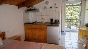 a kitchen with a sink and a counter top at Studios Niki in Koinyra +71 photos