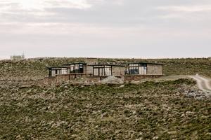 a group of houses on top of a hill at Oudeberg Living- Oudeberg Lodge in Sutherland