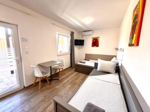 a living room with a couch and a table at Tutti Apartman in Balatonlelle