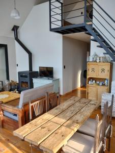 a dining room with a wooden table and a staircase at Cabaña San Charbel in Potrerillos
