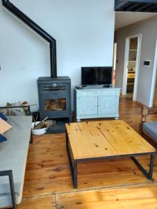 a living room with a fireplace and a coffee table at Cabaña San Charbel in Potrerillos