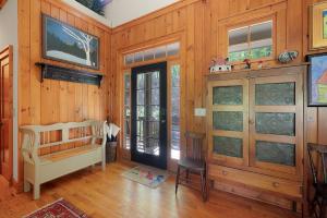a room with a bedroom with wood paneled walls at - Dawsonville, GA - Take in Beautiful Lake Views, Kick Off a Game of Foosball, Cozy Up by the Fireplace, and Unwind on the Scree in Dawsonville