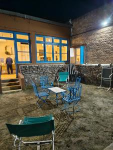 a group of chairs and a table in front of a building at Hostal LA BLANQUITA in San Fernando del Valle de Catamarca