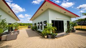a white building with a red roof at Guesthouse AngaLampoe in Lelydorp