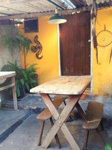 a wooden picnic table with a chair and a lamp at Hospedagem Jabuti no Centro de São Jorge in Sao Jorge +54 photos