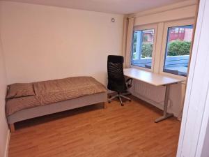 a bedroom with a desk and a bed and a desk and a chair at Rimbo Hem in Rimbo