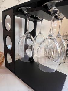 a wine glass holder with four wine glasses at Chácara Orvalho da Chapada in Cavalcante